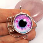 Oko, Srebrny wisior z różowym okiem - srebrny wisior na dłoni