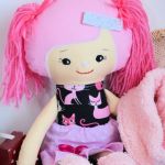 Cukierkowa lalka Edytka 43 cm - wersja zimowa - Poznajcie Edytkę, która ma włosy bawełniane różowe i włóczkowe różowe kitki  Body ma uszyte z bawełny czarnej w różne różowe kotki