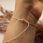 Bransoletka na kremowym sznureczku z perłą - Regulacja bransoletki